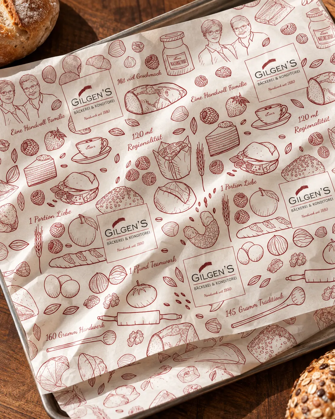 Gilgens Einschlagpapier mit Illustrationsmuster auf frischem Gebäck